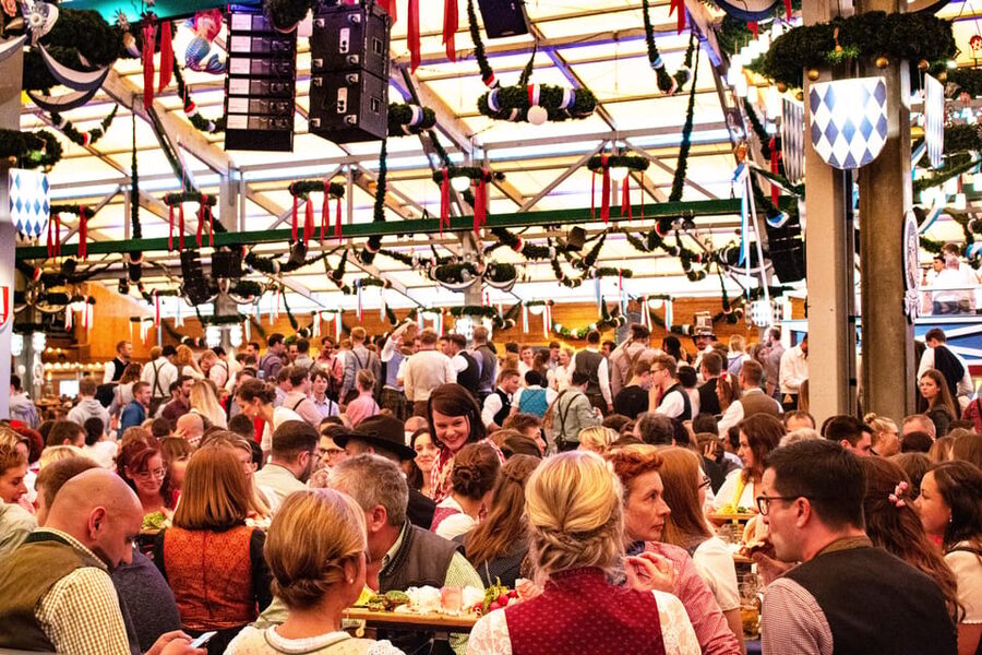 Munich: Oktoberfest Tour with Tent Reservation, Food & Beer - Inside the beer tent with food and two liters of beer