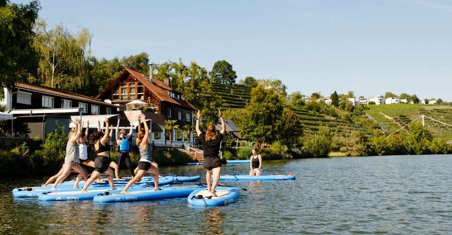SUP Yoga with Guide - One hour of yoga with moving water beneath you